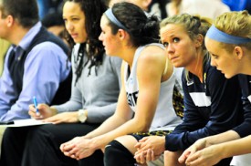 From right to left: Webster University freshman Kylie Fenemor, sophomore Hillary Trimble and junior Maggie Zehner watch from the bench during their team’s 81-65 loss to Eureka College on Feb. 4 at Grant Gymnasium. PHOTO BY SEAN SANDEFUR.