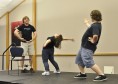 PHOTO BY MEGAN WASHAUSEN (Left to right) Webster students Kevin Lanigan, Paige Andrews-Johnson and Jacob Kelleher play “Sit, Stand, Lean,” an improvisation game where participants must be either sitting, standing or leaning at all times. The event was Chainlink Improv’s end-of-semester show on Monday, April 29.