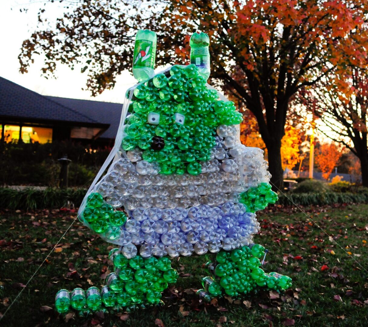 Recycled bottle creature with green accents