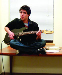 Person playing guitar on a table