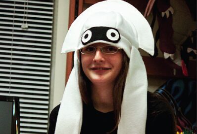 Woman in glasses sporting a fun hat
