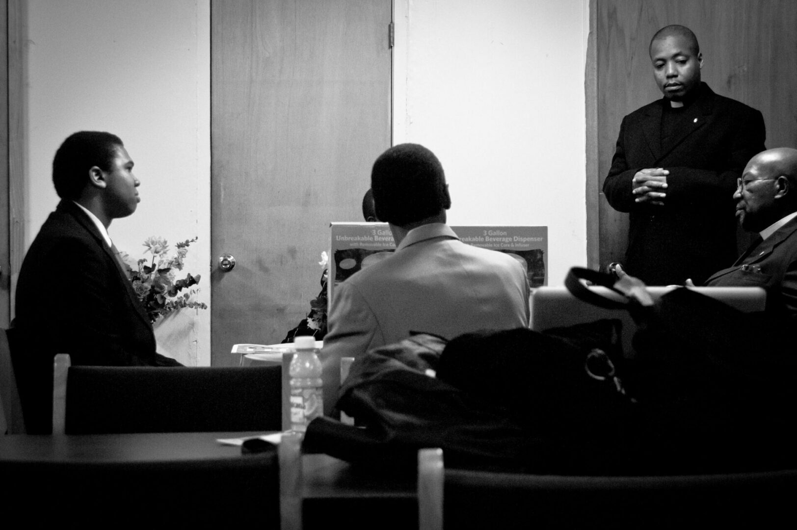 Clergyman standing during a meeting