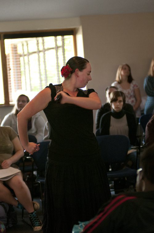 Woman in black dress dancing