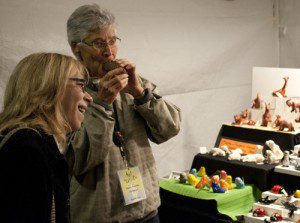 People enjoying ceramic animal display