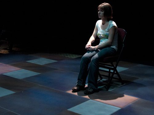 Solo performance in dimly lit space.