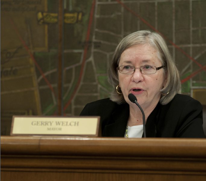 Woman with glasses at microphone
