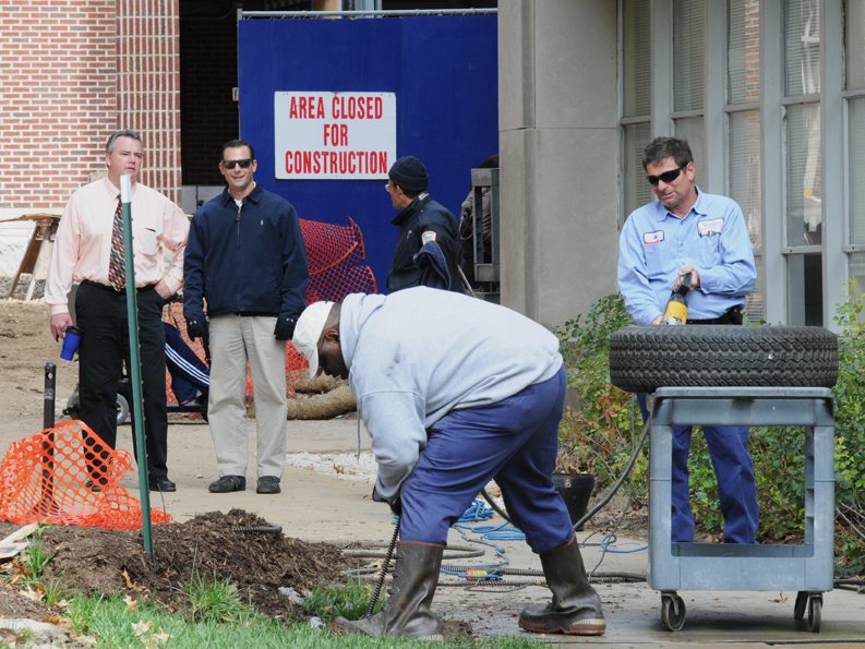 Workers repairing area near closed construction zone