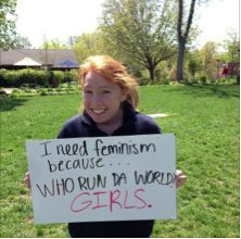 Feminism advocacy with handwritten sign in park