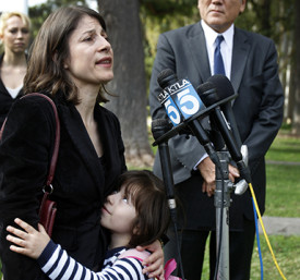 SANTA ANA, CA-NOV. 19, 2013: Dr. Jorge Mancillas, right, listens to his wife, and daughter, Arianna Mancillas, 4, hugs her mom, Norma Esparza, left, while speaking during a press conference outside the Central Justice Center in Santa Ana Wednesday, Nov. 20, 2013. (Photo By Allen J. Schaben / Los Angeles Times)