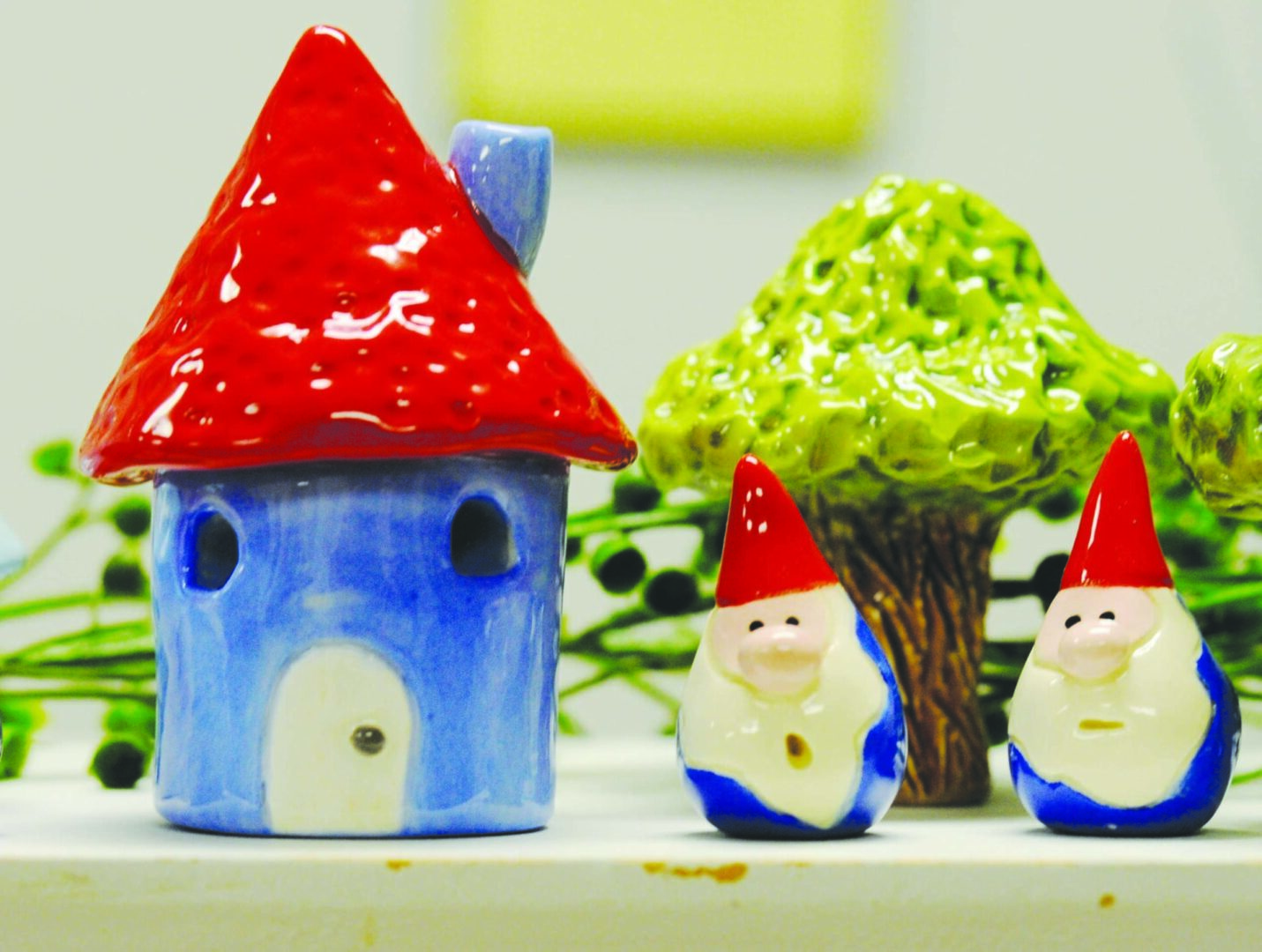 Ceramic house with gnomes and tree figurines