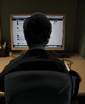 Person using computer in dim room