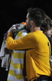 Senior forward Pat McCaffrey is comforted by a teammate after the men's soccer team's SLIAC Championship loss. PHOTO BY MEGAN FAVIGNANO/The Journal