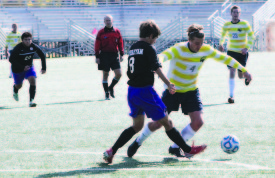 HOLLY SWAN / The Journal Patrick McCaffrey, men’s soccer forward, maneuvers around an Iowa Wesleyan defender at a home game on Saturday Nov. 2. Webster defeated Wesleyan 13-0.