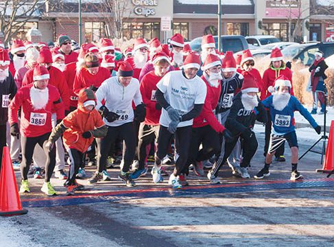 Runners in Santa costumes at race start