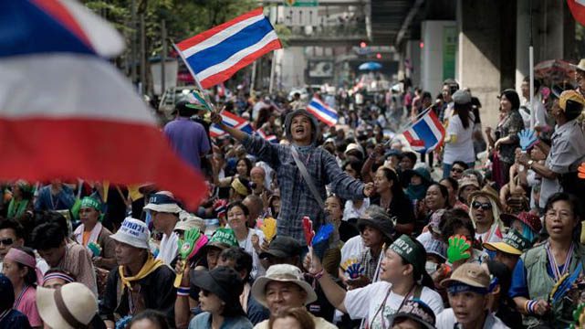 Crowd waving flags at outdoor rally