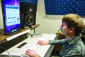 Webster University audio production major Paul Schneider works with his audio equipment. Schneider took a techinical ear class to further his skills as a producer. 