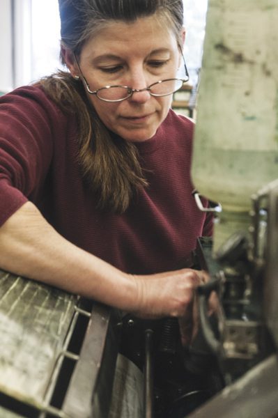 Woman working with industrial machine