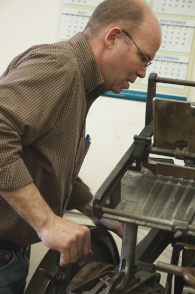 Dan Rath uses a Kluge machine to add sequential numbering to business forms.  PHOTOS BY MEGAN WASHAUSEN/The Journal
