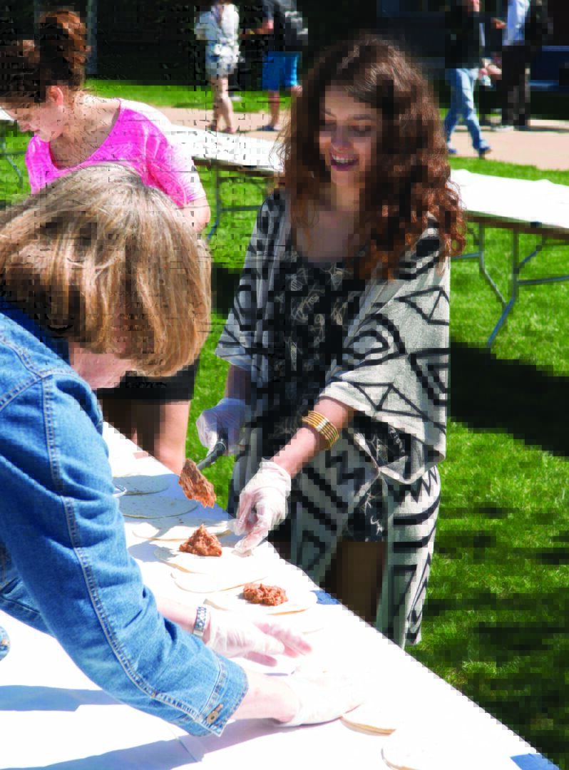 Individuals enjoying an outdoor food festival