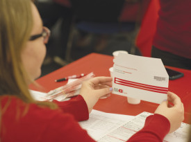 Students swab their cheeks and then place the swab within the envelope. The envelope is then sent on for the student to be registered as a blood marrow donor.