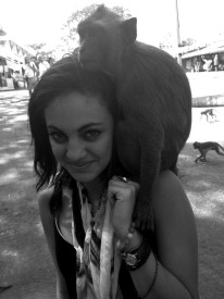 Contributed by Macy Salama A monkey perches on Macy Salama’s shoulder. Food sold by a local encourages the monkeys to get close.
