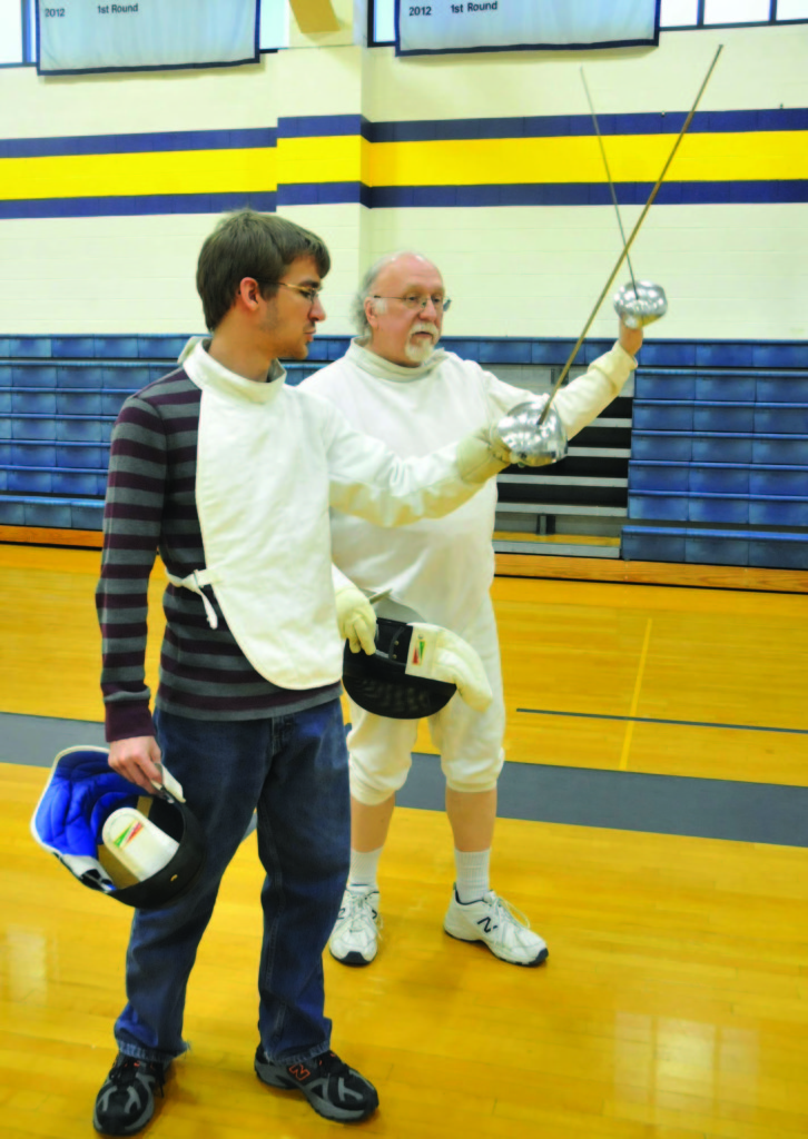 MEGAN WASHAUSEN / The Journal Michael Long works one-on-one with student Kevin Conrad. Conrad took Fencing I with Long and said he returned because the sport is fun and he enjoys the exercise. 