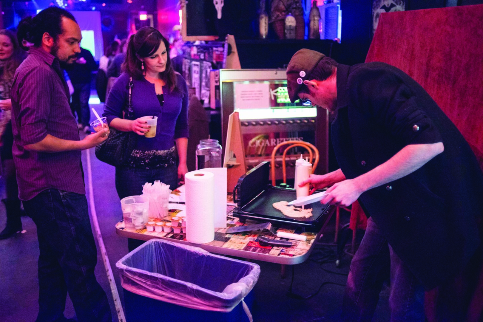 Indoor gathering with art demonstration.