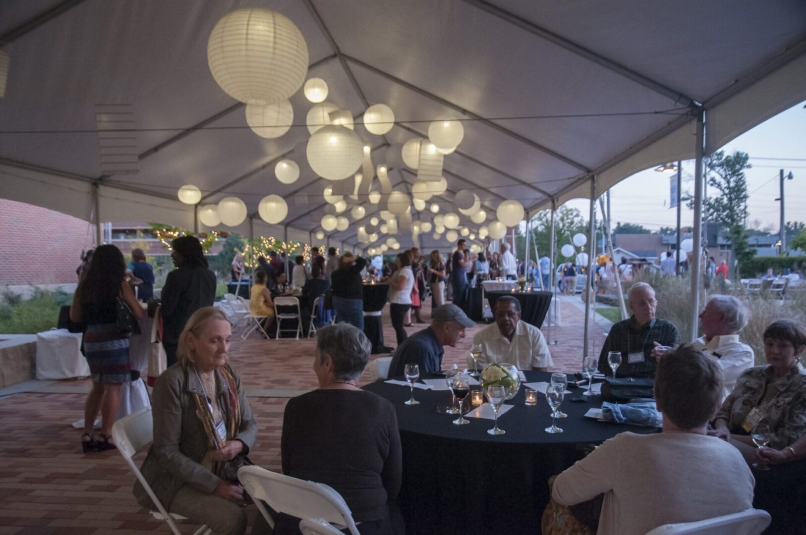 Outdoor evening event under a tent
