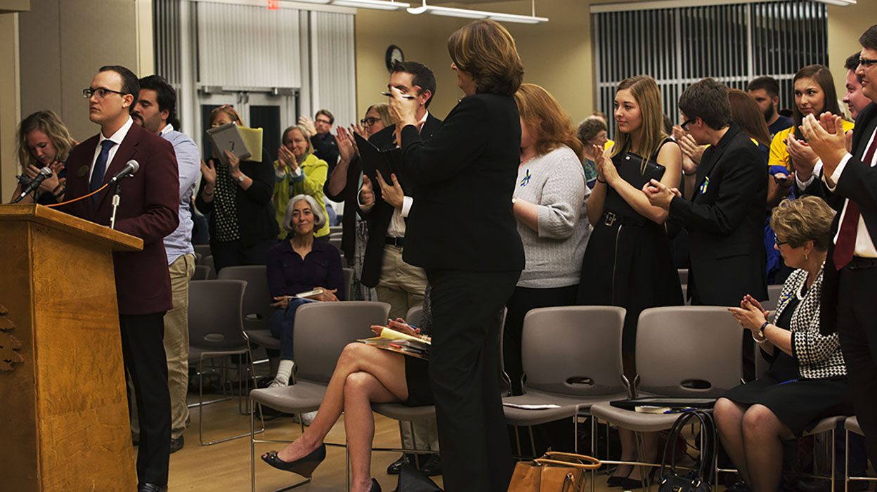 People clapping in a meeting room