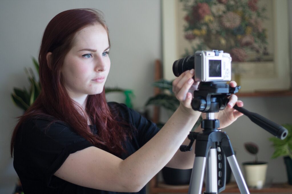 Woman setting up camera on tripod