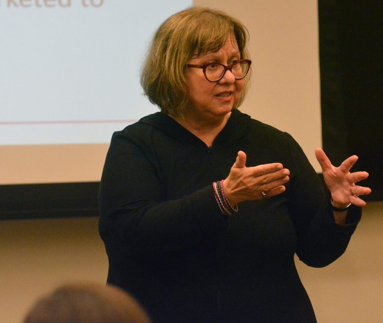 Speaker gesturing during a presentation.