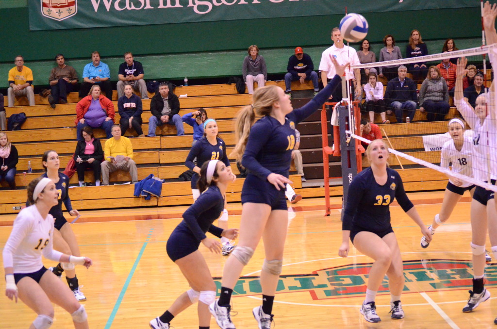 Senior Jenny Howard tries to tip the ball over the net. Howard had five kills in the game. JORDAN PALMER/THE JOURNAL