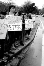 Students line up, holding sings,  at the intersection of Big Bend Boulevard and Edgar Road for sexual assault awareness. 