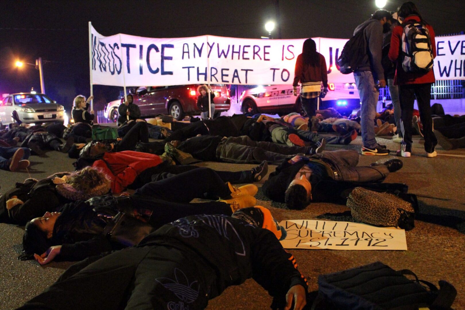 Protestors lying on street at night