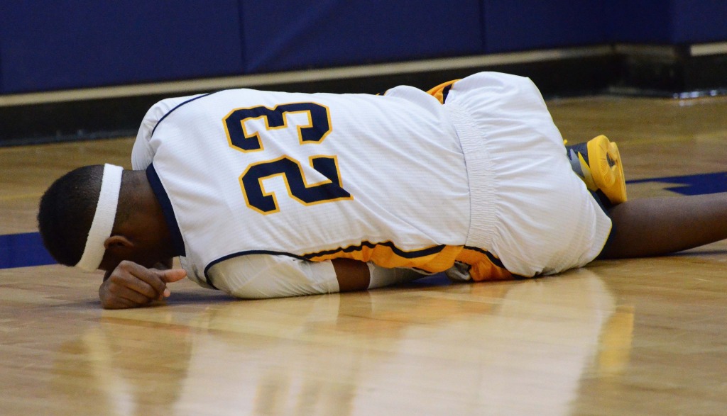 JORDAN PALMER/ The Journal Ahmad Smith falls to the floor in pain after he suffered a sprained ankle in Webster’s win over Fontbonne on Jan. 17. He is expected to miss at least a week. 