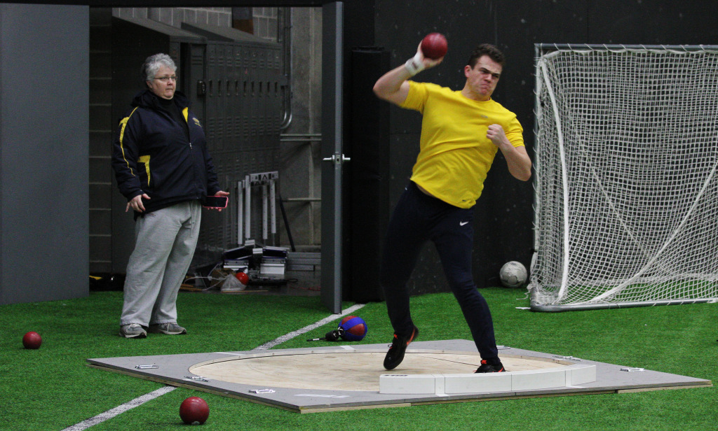 JUSTIN CUNNINGHAM/The Journal Junior Jeff Barlow practices his throws during track and field practice, while throwing Coach Sydney Laster observes. Barlow is one of the most experienced members of the track and field team.