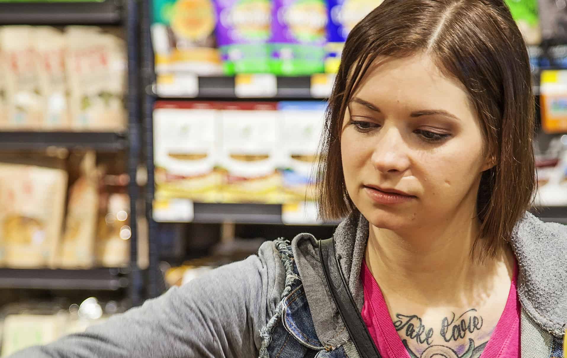 Shopper browsing food products on shelf