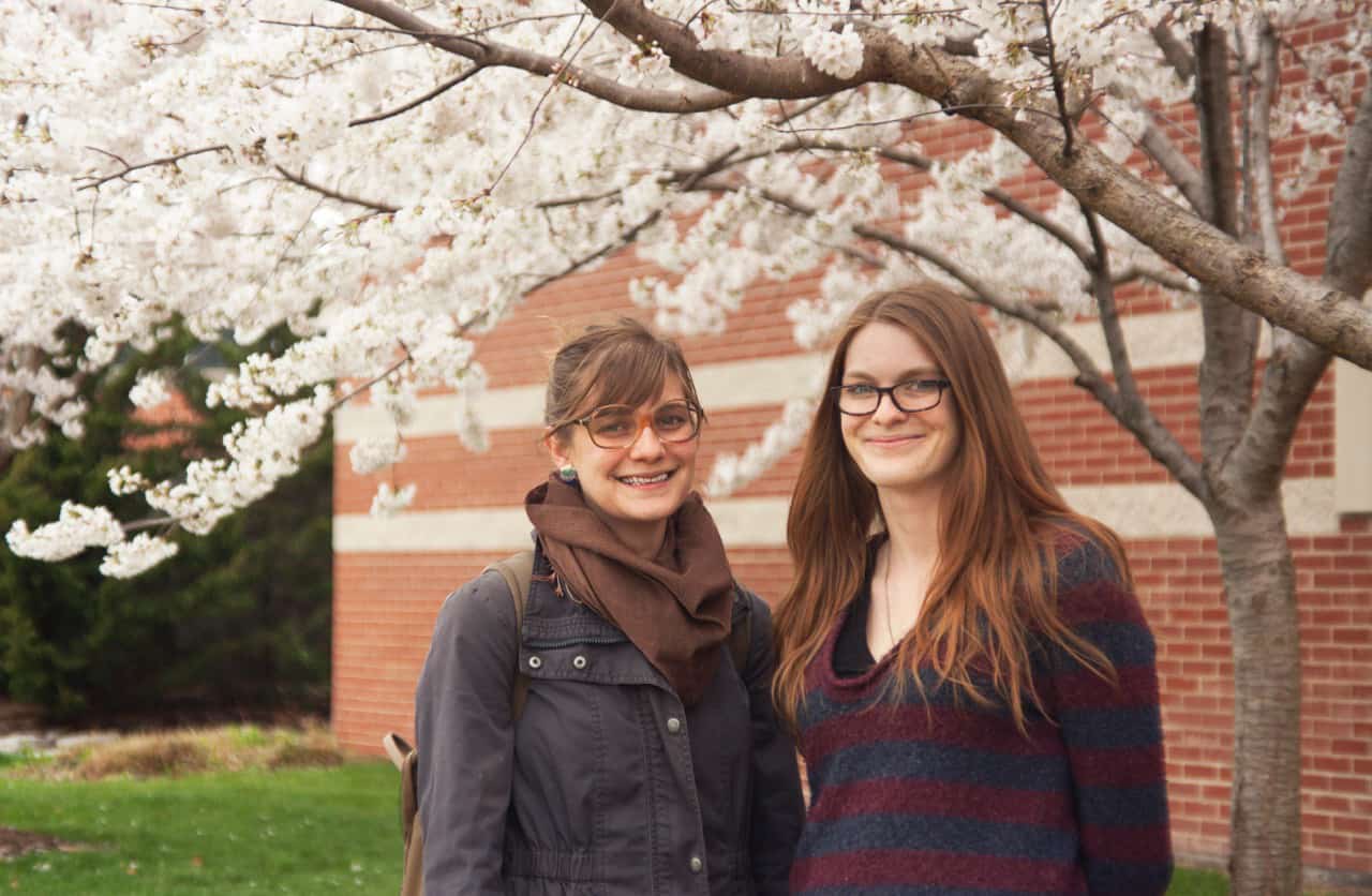 Friends enjoying springtime blossoms outdoors.