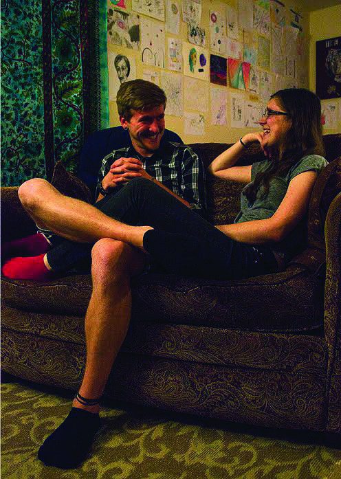 Friends sharing a laugh on sofa
