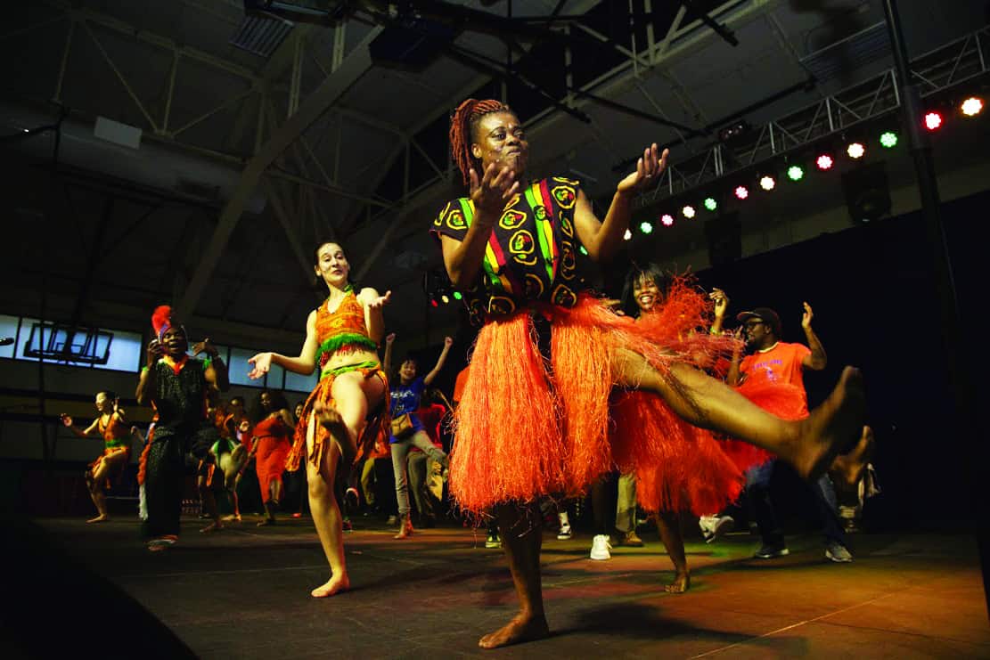 Energetic dancers in vibrant traditional costumes.