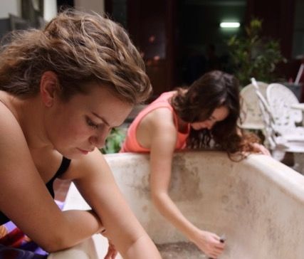 Women cleaning an outdoor tub
