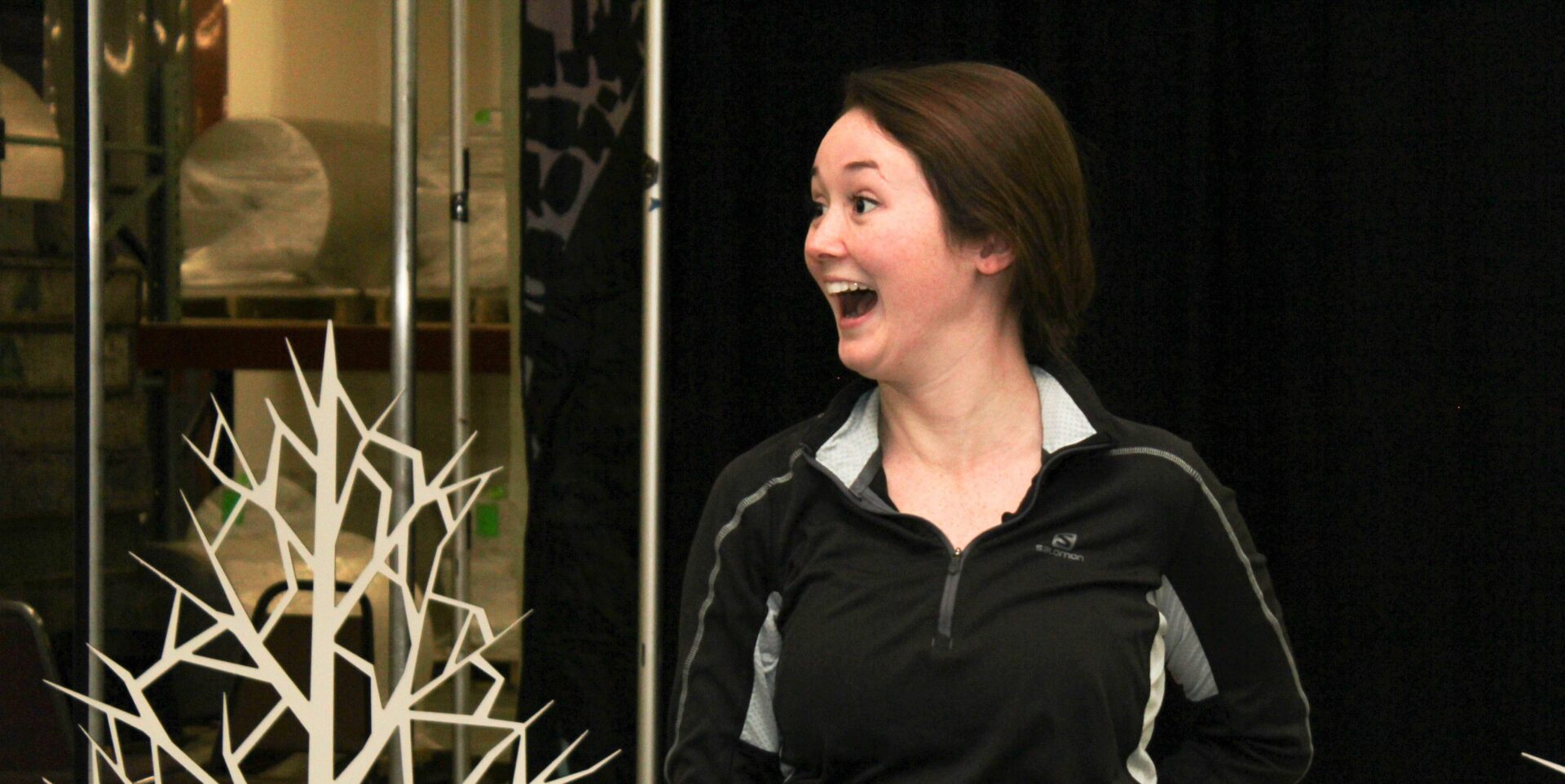 Woman surprised near decorative tree sculpture