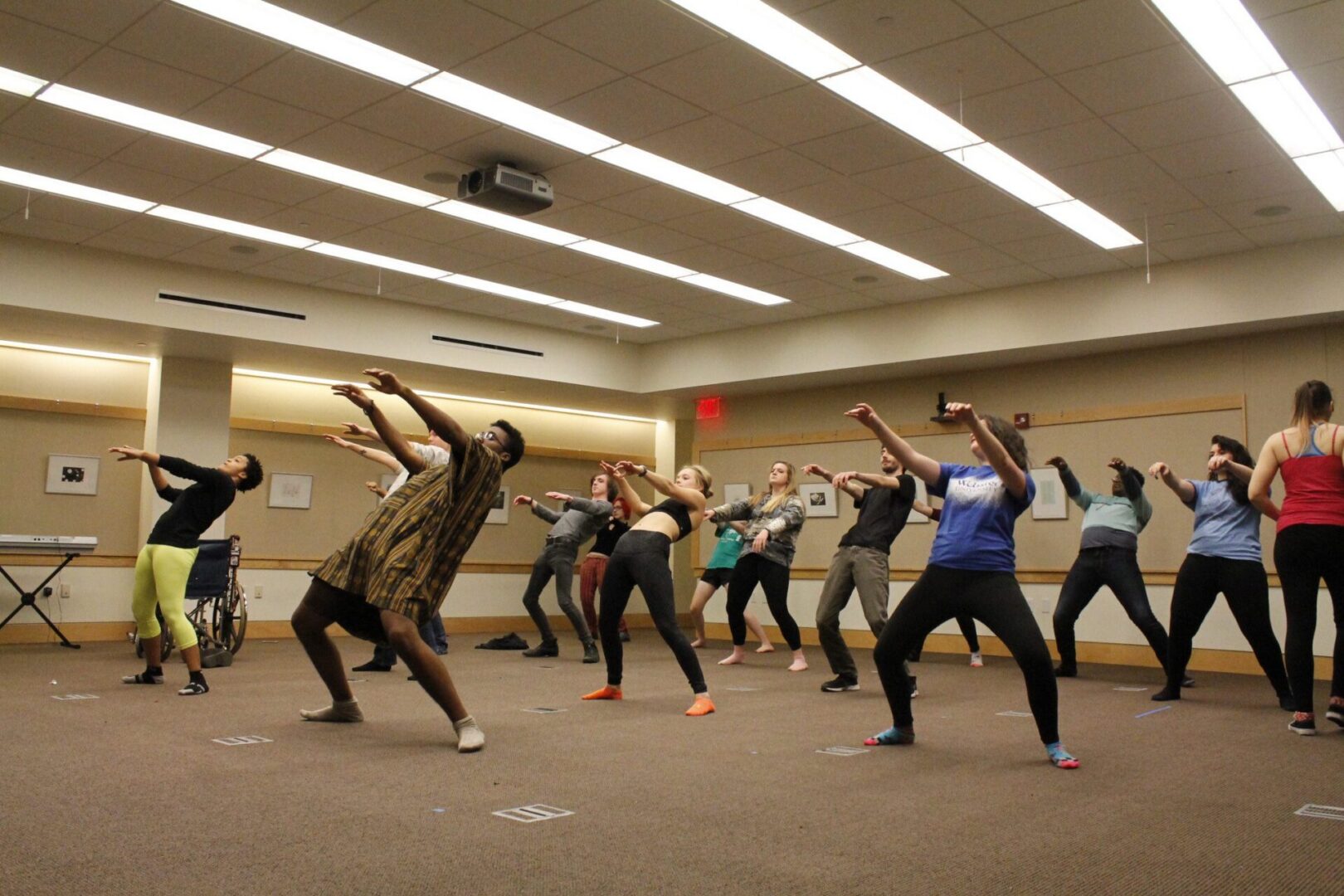 People rehearsing dance moves indoors