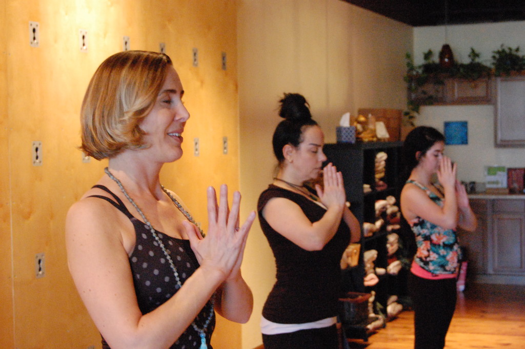 STL Symphony Associate Concertmaster Heidi Harris teaches a class at Agape Yoga Studio. Harris is teaching a workshop for Webster music students about how to use yoga to help perform to the best of their ability. JARROD PHILLIPS / The Journal