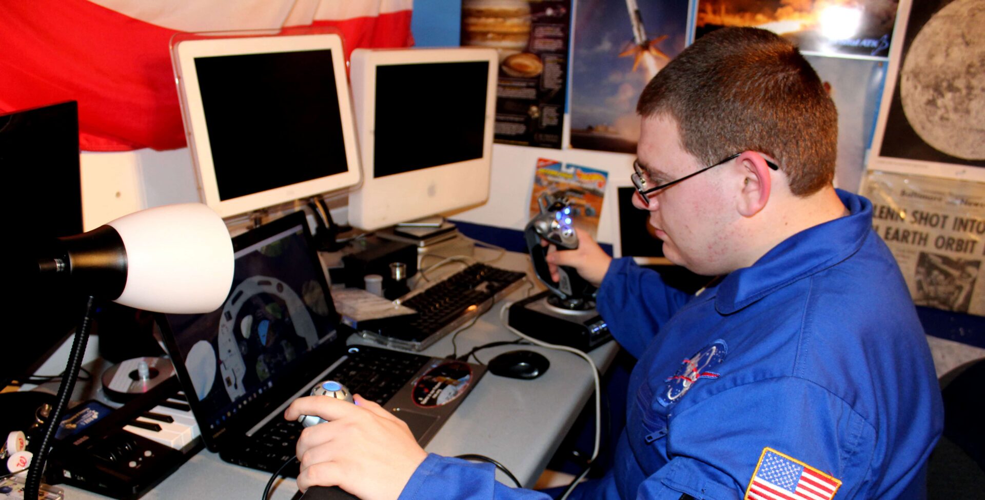 Person in space suit using flight simulator