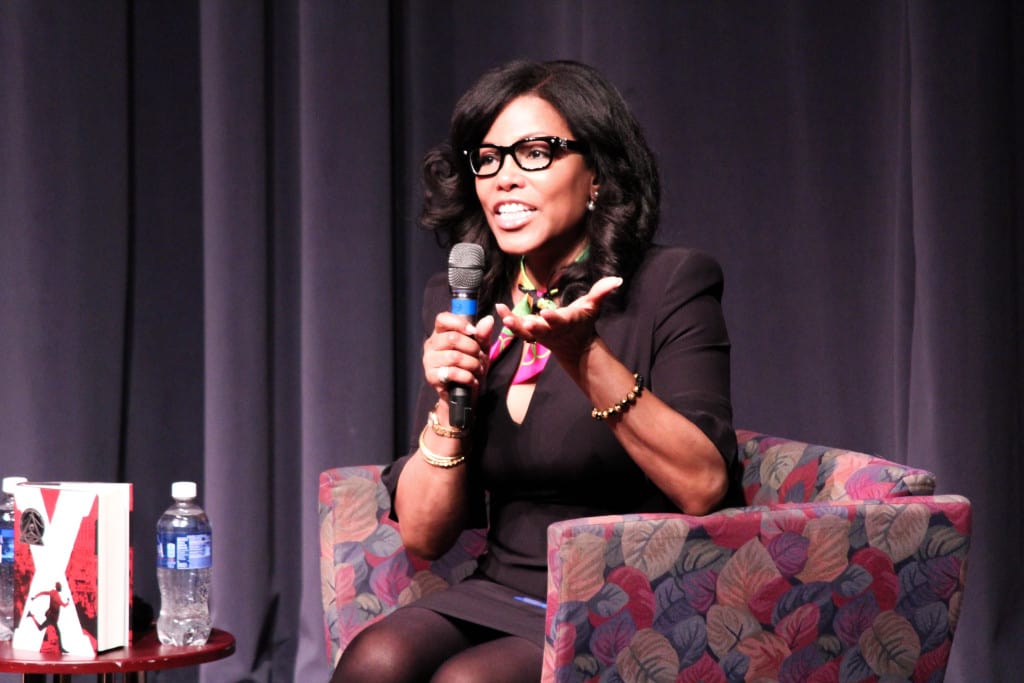 Woman in glasses talking at event