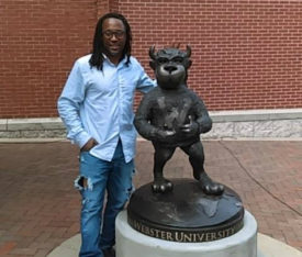 Chorsie Martin poses next to Webster's new Gorlok statue Aug. 1. | Contributed photo