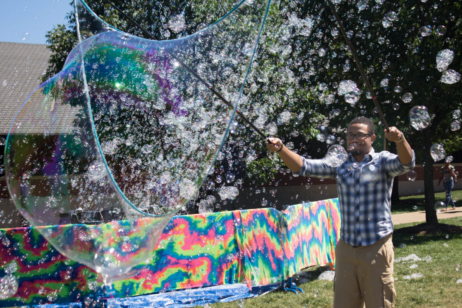 Person making colorful bubbles in park