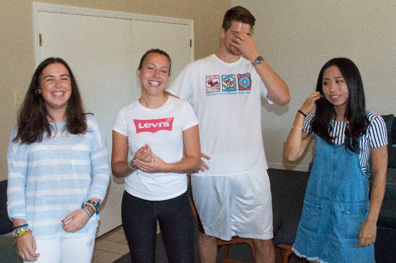 Four friends smiling and standing