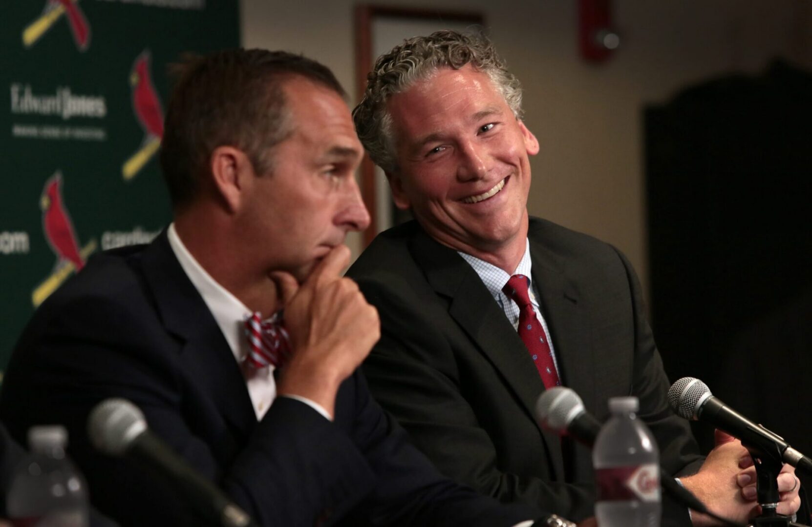 Smiling man in a suit at microphone